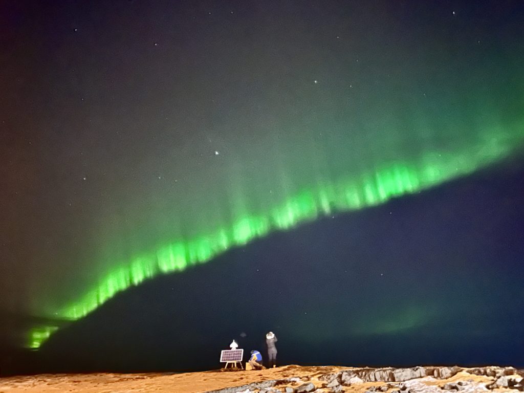 Iceland | Aurora borealis | January 2024.
People looking out and up at the Northern lights in the sky